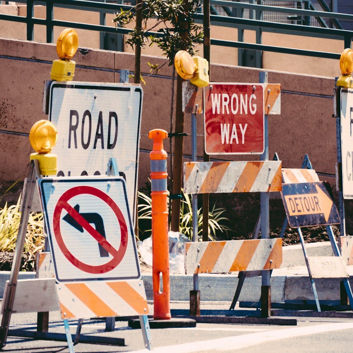 assorted-color signage lot on road during daytime